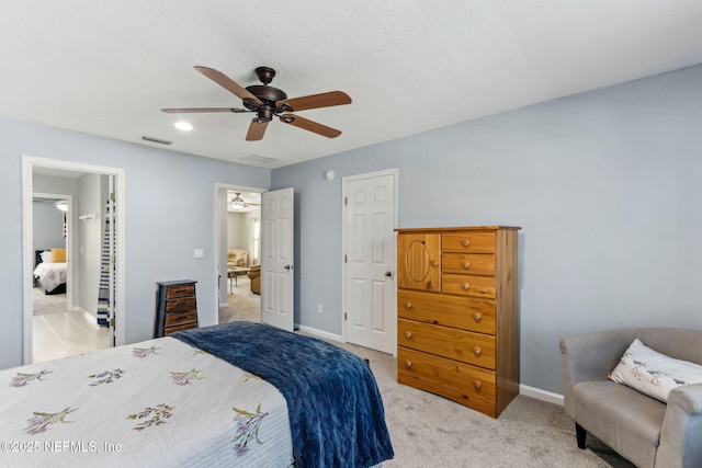 bedroom with light carpet, baseboards, visible vents, and ceiling fan