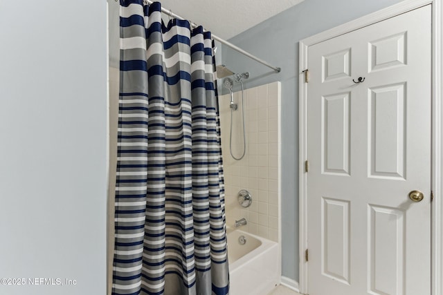 bathroom featuring shower / tub combo and a textured ceiling