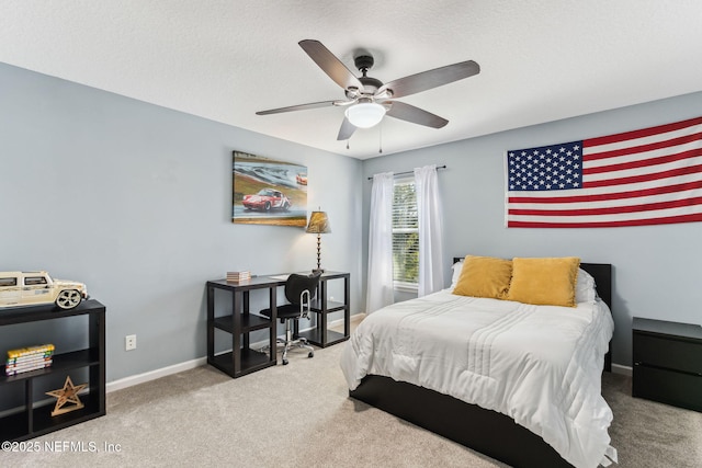 bedroom with a ceiling fan, a textured ceiling, baseboards, and carpet flooring