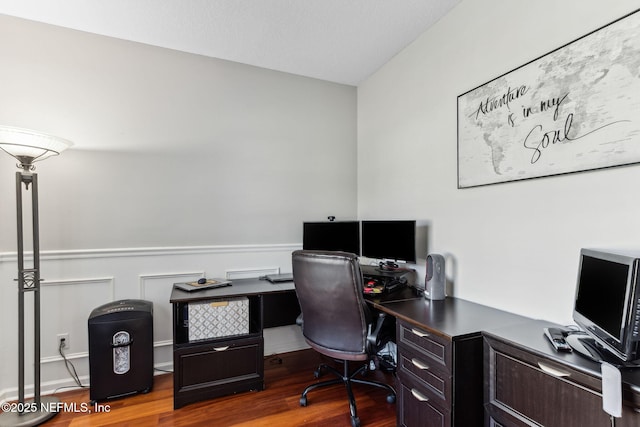 office area with wood finished floors and wainscoting