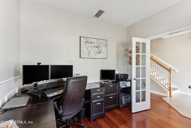 home office with french doors, dark wood-style flooring, visible vents, and baseboards