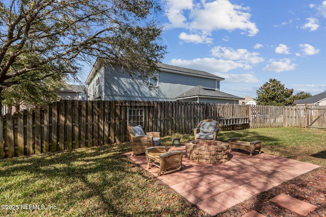 view of yard with a fenced backyard, a fire pit, and a patio