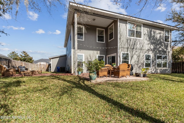 rear view of house with a lawn, fence, cooling unit, and a patio