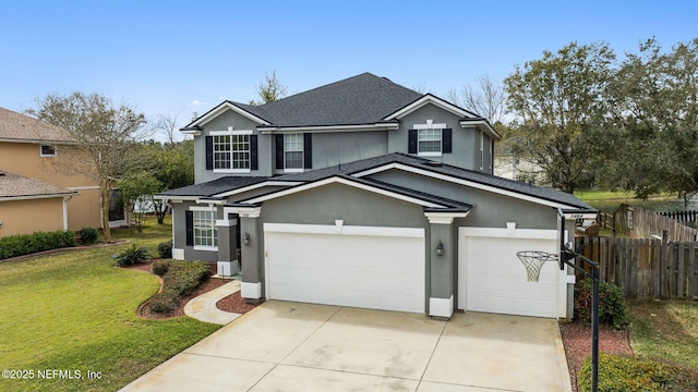 traditional home featuring stucco siding, a front yard, fence, a garage, and driveway