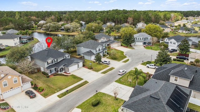 birds eye view of property with a water view and a residential view