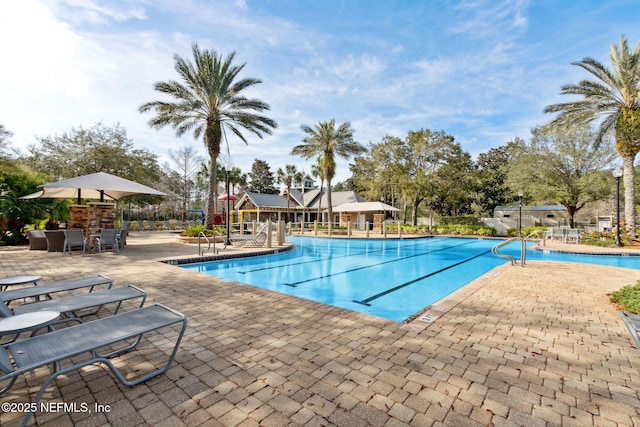 community pool with a patio area