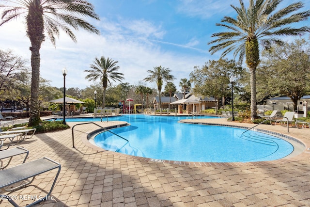 community pool with a patio area