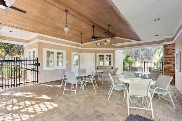 view of patio / terrace with outdoor dining area, fence, and a ceiling fan