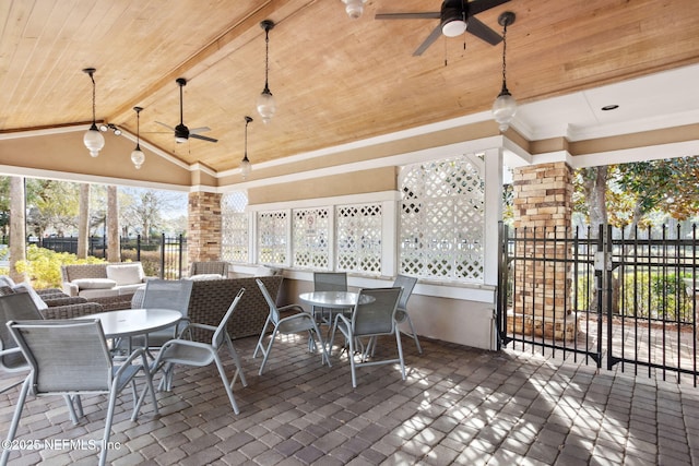 view of patio featuring a ceiling fan, outdoor dining area, and fence