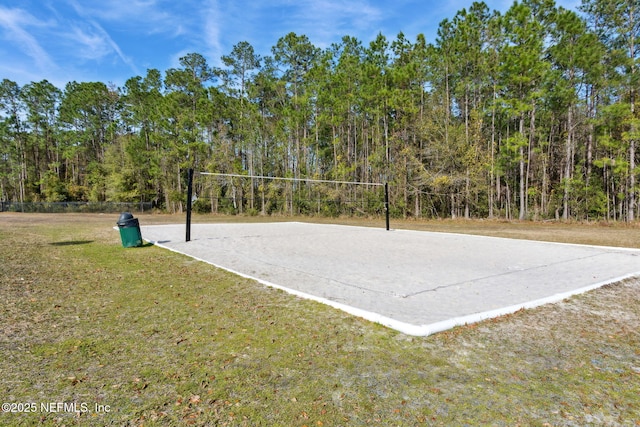 surrounding community with a lawn and volleyball court