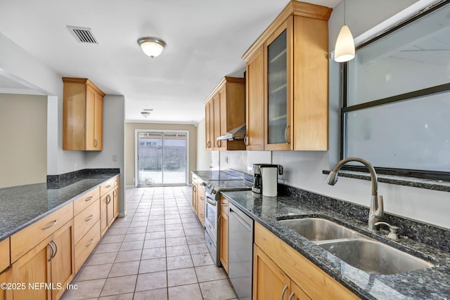 kitchen with light tile patterned floors, visible vents, appliances with stainless steel finishes, wall chimney range hood, and a sink