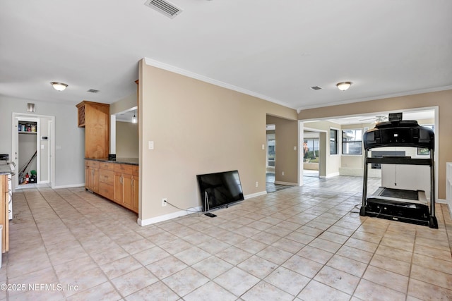 workout room with baseboards, light tile patterned flooring, visible vents, and crown molding