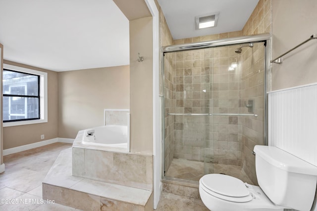 bathroom with a stall shower, a garden tub, toilet, and tile patterned floors