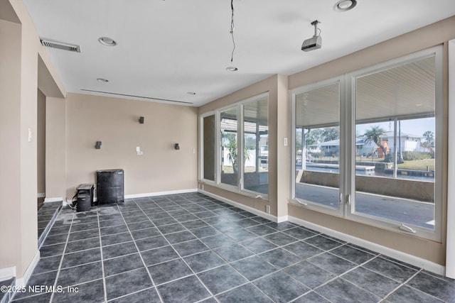 unfurnished room with dark tile patterned flooring, recessed lighting, visible vents, and baseboards