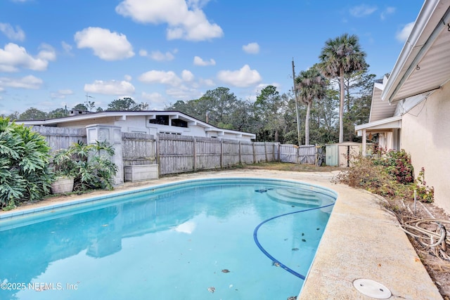 view of swimming pool with a fenced backyard and a fenced in pool