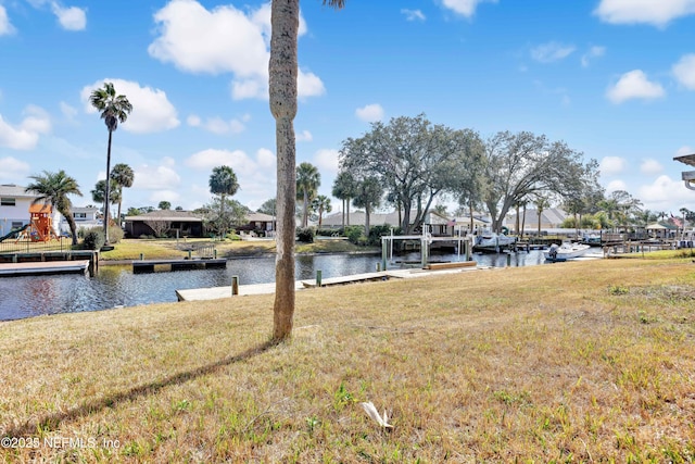 dock area with a water view and a lawn