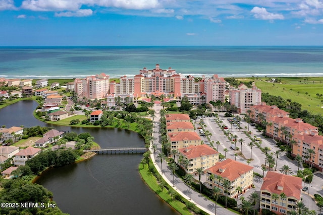 birds eye view of property with a water view and a city view