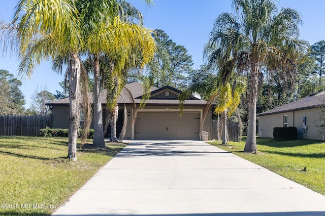 view of front facade with driveway, an attached garage, fence, and a front yard