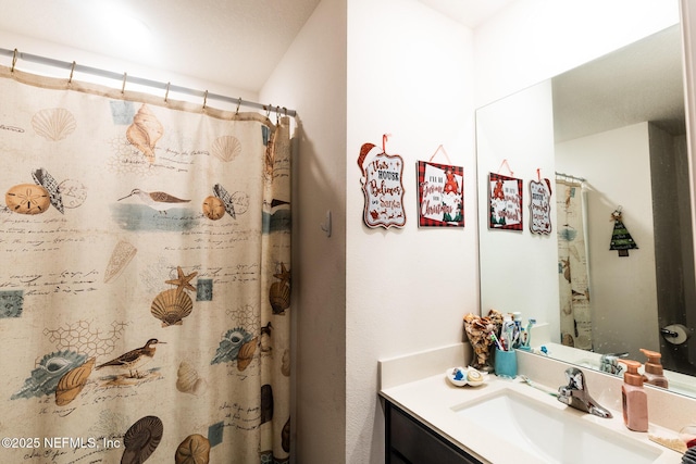 full bathroom with a shower with shower curtain and vanity