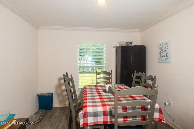 dining space featuring ornamental molding, wood finished floors, and baseboards