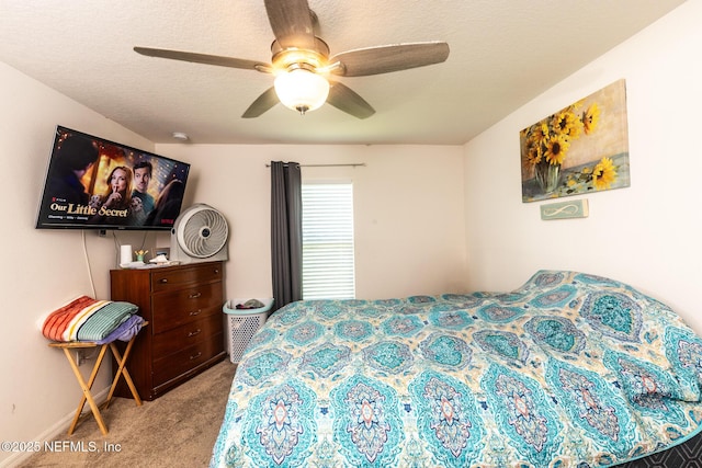 carpeted bedroom featuring a textured ceiling and ceiling fan