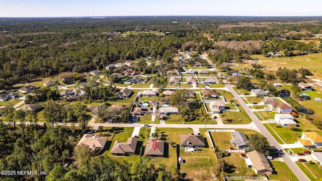 aerial view featuring a residential view and a forest view