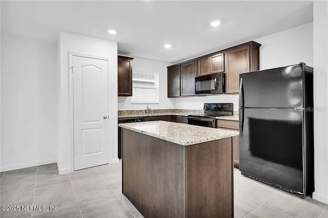 kitchen with a kitchen island, light stone counters, dark brown cabinets, black appliances, and recessed lighting