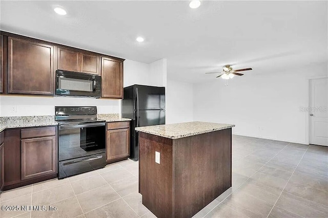 kitchen featuring a center island, ceiling fan, dark brown cabinets, light stone countertops, and black appliances