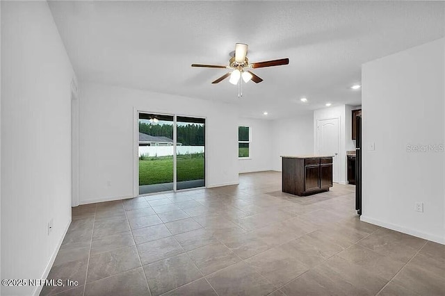 spare room with recessed lighting, ceiling fan, baseboards, and light tile patterned floors