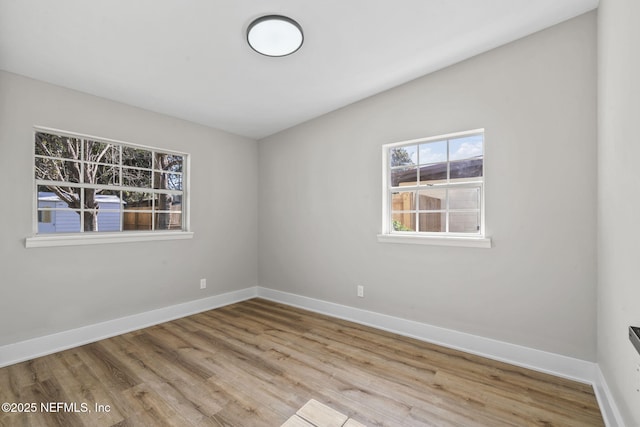 unfurnished room featuring wood finished floors and baseboards