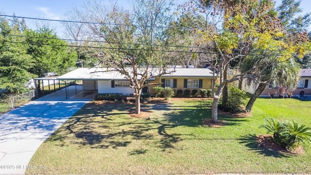 view of front facade with a carport, a front yard, and concrete driveway