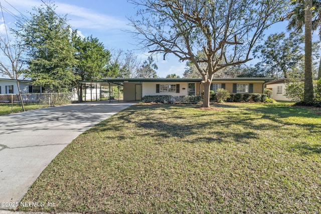 ranch-style house featuring a carport, a front yard, fence, and driveway