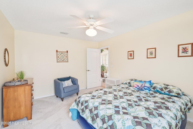 bedroom with carpet, visible vents, and a ceiling fan