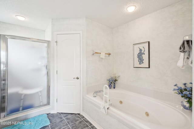 bathroom with a stall shower, tile patterned flooring, a tub with jets, and a textured ceiling