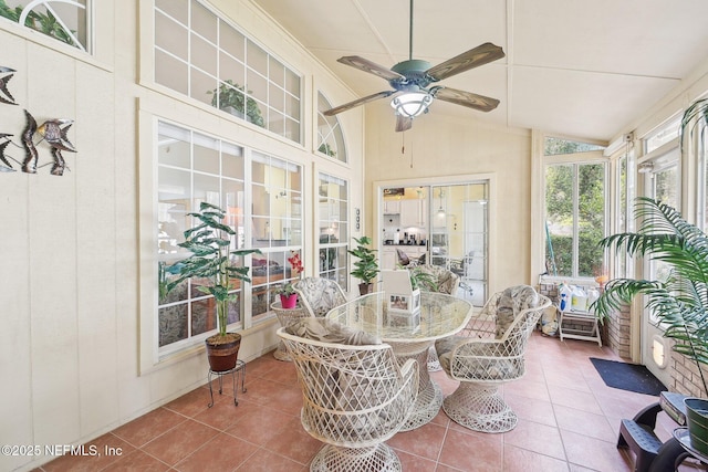 sunroom featuring a ceiling fan and lofted ceiling