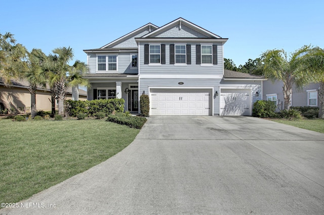 view of front of home with a front yard, concrete driveway, and an attached garage