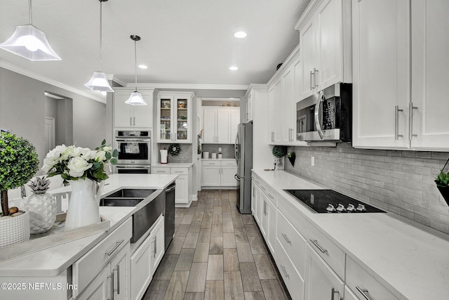 kitchen featuring white cabinetry, appliances with stainless steel finishes, and tasteful backsplash