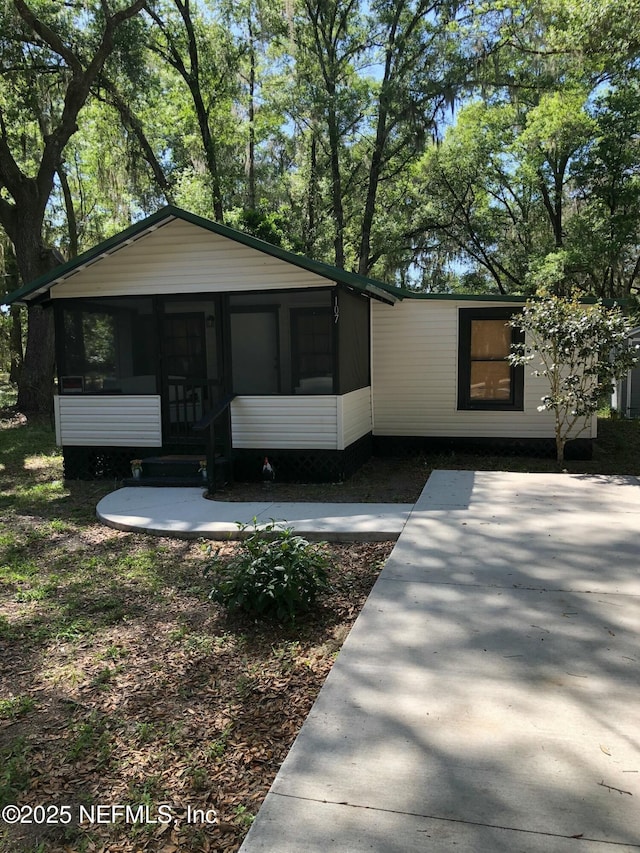 view of front of property featuring a sunroom