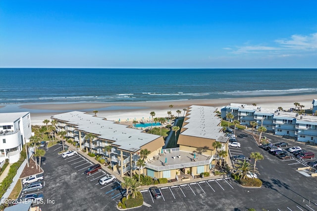 bird's eye view featuring a view of the beach and a water view