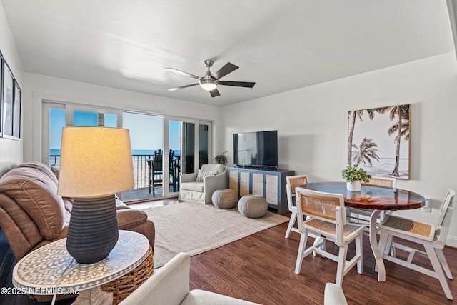 living room with wood finished floors and ceiling fan