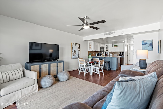 living room with visible vents, a ceiling fan, dark wood finished floors, recessed lighting, and baseboards