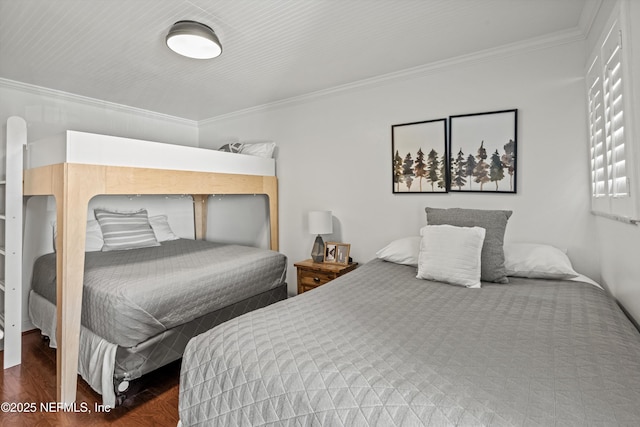 bedroom with ornamental molding and wood finished floors