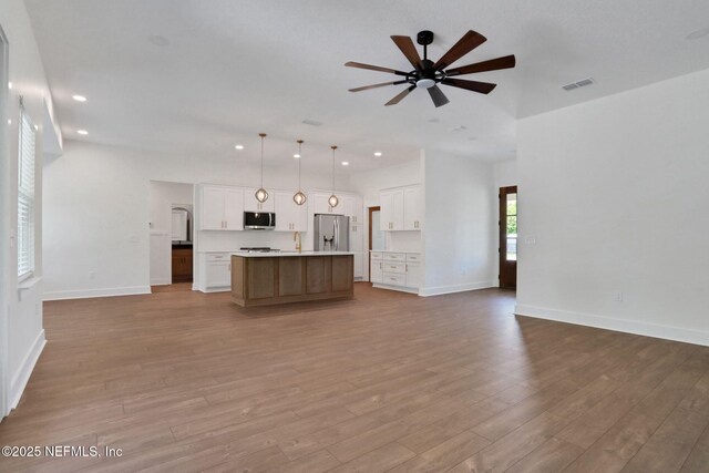 44024 Breezy Ln, Callahan, FL 32011 - kitchen featuring appliances with stainless steel finishes, open floor plan, ceiling fan, a center island with sink, and recessed lighting