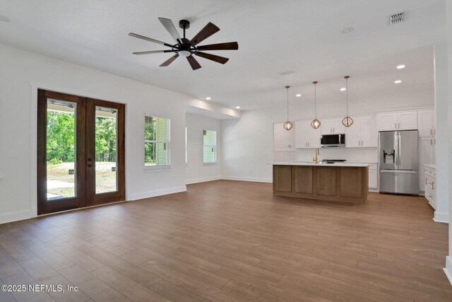 44024 Breezy Ln, Callahan, FL 32011 - unfurnished living room with healthy amount of natural light, french doors, wood finished floors, recessed lighting, and baseboards