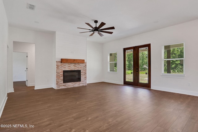 44024 Breezy Ln, Callahan, FL 32011 - unfurnished living room with ceiling fan, a fireplace, dark wood-style flooring, and baseboards