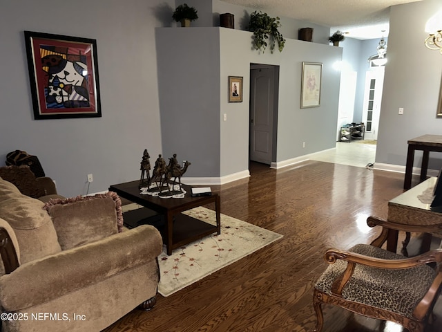 living room with baseboards and wood finished floors