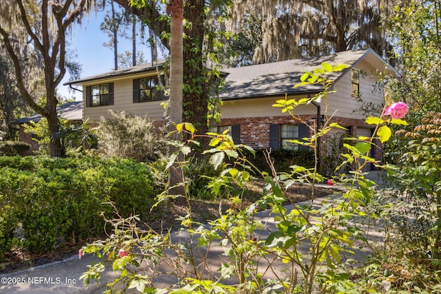 view of side of home featuring brick siding