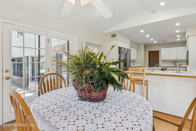 dining room featuring visible vents, light wood-style flooring, recessed lighting, lofted ceiling, and ceiling fan