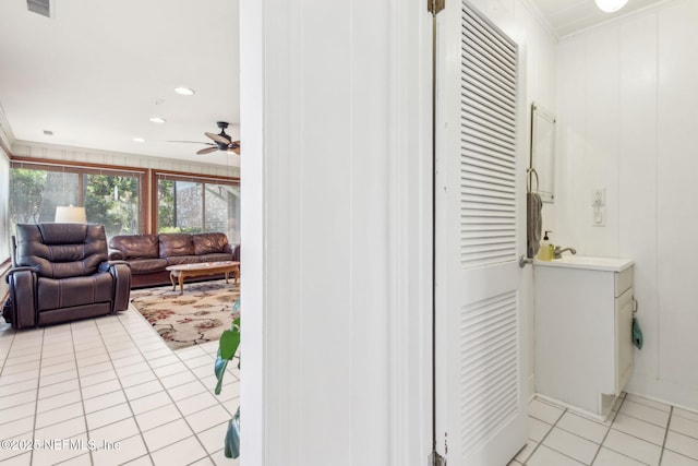 interior space with ceiling fan, light tile patterned floors, recessed lighting, and ornamental molding