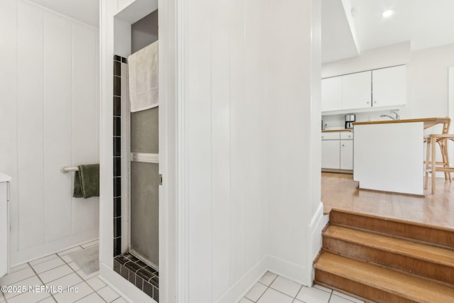 bathroom featuring tile patterned flooring and a stall shower